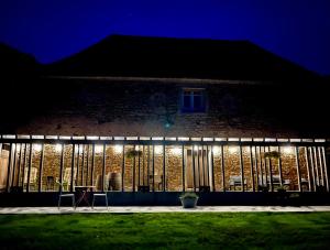 a building with lights on it at night at Luxe tent met rust, ruimte en uitzicht in Saint-Sulpice-dʼExcideuil