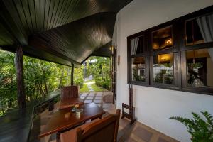 a living room with a desk and a window at Chaweng Bay View Resort by Smith & Appy in Ko Samui