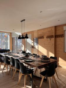 a large dining room with a large wooden table and chairs at Loft-chalet 12 pers - Billiards - Cinéma - 10 min ski in La Cabanasse