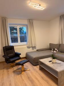 a living room with a couch and a chair at Appartement Kodra in Sonnberg