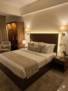 a large bedroom with a large bed and a chair at Hanuman Heritage in Chikmagalūr