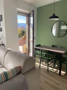 a living room with a couch and a table at La Dimora di Borgo in Borgo San Dalmazzo