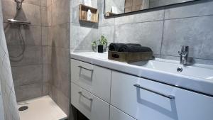 a bathroom with a white sink and a shower at Balcon Vue Panoramique - Parking - Gare 200m in Vienne +15 photos