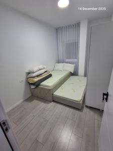 a small bedroom with a bed in a room at Shala apartment in Mitrovicë