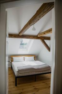 a bedroom with a bed in a room with wooden ceilings at Apartment mit Connection am Müritz National Park 