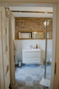 a bathroom with a sink and a brick wall at Apartment mit Connection am Müritz National Park 