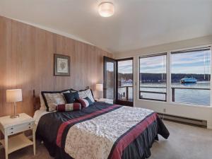 a bedroom with a large bed and a large window at Friday Harbor Lights in Friday Harbor