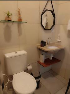 a bathroom with a white toilet and a sink at Recanto Nova Vida in Ibiapina +16 photos
