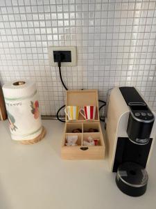 a coffee maker and a box on a kitchen counter at La Dimora di Siena in Tognazza