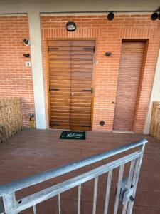 two wooden garage doors on a brick building at La Dimora di Siena in Tognazza