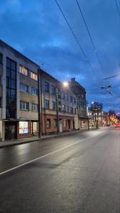an empty city street at night with a building at Kaunas Studios - RentA 18 in Kaunas
