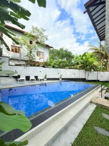 a swimming pool in the backyard of a villa at Pineapple Surf Villa in Ahangama +14 photos