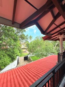 a view from the balcony of a house with a red roof at Pineapple Surf Villa in Ahangama