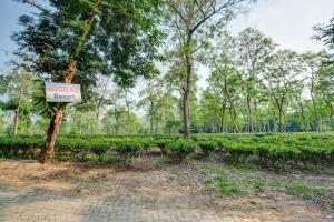 a sign for a garden in a park at Hotel O Heritage Nest Resort Kazirnga in Kāziranga