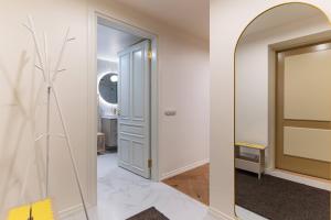 a hallway with a door and a mirror at Fellin Apartment in Viljandi +32 photos