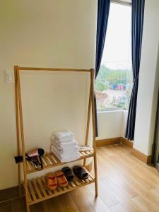 a room with a shelf with shoes and a window at Khách Sạn Trung Loan in Ninh Hải