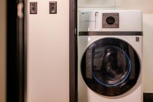 eine Waschmaschine steht neben einem Kühlschrank in der Unterkunft Penthouse City Overlook 2BR Apartment - free parking in Appleton