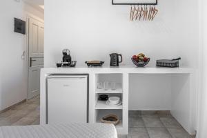 a kitchen with a white counter top with a sink at NAMASTEmilos in Pachaina