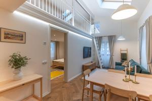 a living room with a dining room table and a staircase at Fellin Apartment in Viljandi