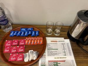 a wooden table with a plate of food and drinks at Hotel Crescent in Srinagar