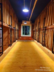 an empty hallway with a window in a building at Mi Amor Luxury Hostel located in South Island Center in Phú Quốc
