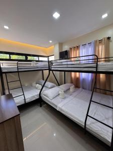 a group of bunk beds in a room at Kugi Hostel - Self Check-in Capsule Hostel near Cebu Airport in Cogon