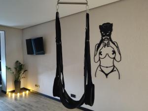 a hanging hammock with a dog on the wall at Тематичні апартаменти in Zhytomyr