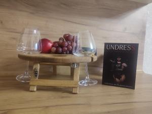a miniature table with two wine glasses and a book at Тематичні апартаменти in Zhytomyr