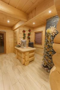 a room with a desk and a christmas tree at Villa Alexandra jacuzzi i sauna in Kościelisko