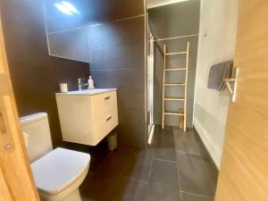 a bathroom with a toilet and a glass shower at Résidence Costa Vermella, vue mer et montagne au calme in Cerbère +50 photos