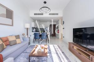 a living room with a couch and a table at The Gate Executive 2BR on Masdar City by Ayla in Abu Dhabi Intl