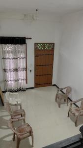 a room with chairs and a door and a room with a door at Sihilal Family Rest House in Bandarawela