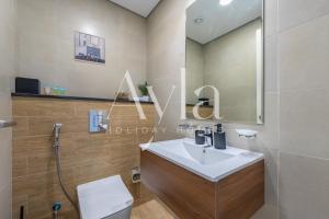 a bathroom with a sink and a toilet at The Gate Executive 2BR on Masdar City by Ayla in Abu Dhabi Intl +21 photos