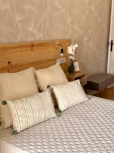 a bed with two pillows on top of it at Apartamento Coque -Cazorla in Cazorla