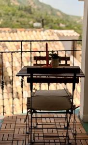a table and a chair on a balcony at Apartamento Coque -Cazorla in Cazorla