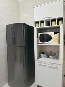 Kuchyň nebo kuchyňský kout v ubytování Aconchego econômico