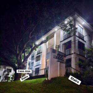 a building with signs in front of it at night at Casa Josa in Antipolo