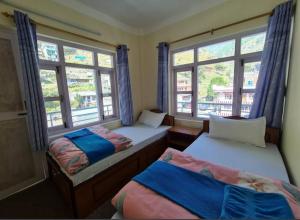 En eller flere senge i et værelse på Royal Himalaya Hotel & Lodge