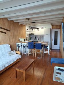 a living room with a couch and a table at Logement 48m2- 2 chambres in Orcières