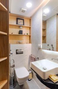 a bathroom with a white sink and a toilet at Large Comfort Duplex Casablanca Center in LʼOasis +12 photos