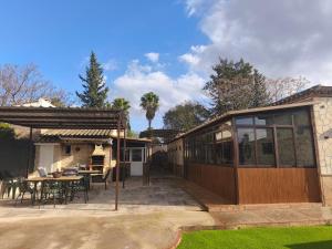 a house with a patio with a table and chairs at RURAL EL SANTISCAL in Arcos de la Frontera