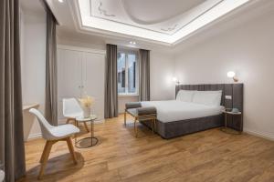 a bedroom with a bed and a table and a chair at SM Vatican Relais B&B in Rome