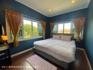 a blue bedroom with a bed and two windows at Mountain Pool Villa Suan Pheung in Suan Phung +35 photos