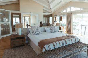 a bedroom with a large bed and a large window at Dune Rose Yzerfontein Villa in Yzerfontein +55 photos