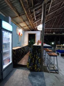 un restaurante con mesa, sillas y nevera en B&B G&H home Zanzibar, en Pingwe