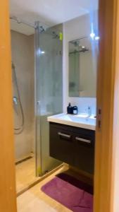 a bathroom with a shower and a sink and a mirror at Studio de standing à maarif in Maarif +4 photos