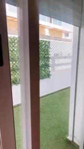 a window with a view of a green yard at Studio de standing à maarif in Maarif