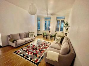 a living room with a couch and a table at Central Hub in Brussels