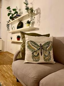 a butterfly pillow on a couch in a living room at Central Hub in Brussels
