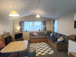 a living room with a couch and a table at Ollys House in Prestatyn